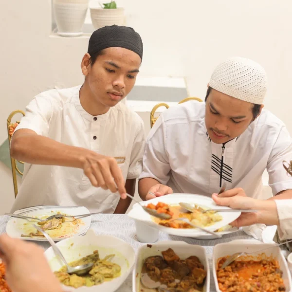 brother-enjoying-food-on-eid-mubarak-moment-2023-11-27-05-05-48-utc